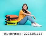 Full length photo of sweet dreamy lady wear yellow t-shirt looking empty space packing suitcases isolated turquoise color background