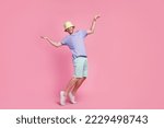 Small photo of Full length photo of joyful dude boy enjoy party stand toes good mood empty space isolated on pink color background