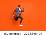 Full body profile photo of active person look empty space hurry rush isolated on orange color background