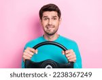 Small photo of Photo portrait of attractive young guy hold steering wheel bite lips confused wear trendy blue garment isolated on pink color background