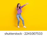 Full body photo of astonished glad lady raise opened arms look empty space isolated on yellow color background