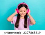 Photo of young funky girl brunette hair wear pink t-shirt listen music stereo sound high quality itunes isolated on blue color background