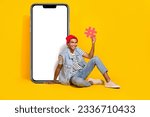 Small photo of Full length photo of sweet cute man wear jeans outfit holding hash tag device empty space isolated yellow color background
