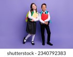 Small photo of Photo of two school kids ready for first day buying supply for learning isolated bright color background