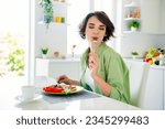 Photo of funky dreamy lady dressed green shirt enjoying tasty meal closed eyes indoors house kitchen