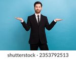 Photo of happy smiling clerk wear black tuxedo comparing arms empty space isolated blue color background