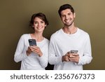 Photo of pretty cute wife husband dressed white shirts typing apple iphone samsung modern devices isolated brown color background