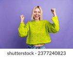 Small photo of Photo of lucky excited woman dressed knitted sweater shouting yeas rising fists isolated violet color background