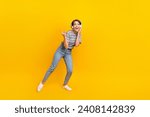 Full size photo of carefree positive girl demonstrate heavy metal symbol empty space isolated on yellow color background