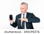 Old handsome man in business suit pointing to the phone