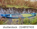 Sunken Blue Boat In A Pond....