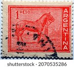 Small photo of Cairo, Egypt, November 5 2021, A postage stamp from Argentina with the image of Caballo Criollo breed horse which is the native horse of Argentina, Circa 1959, Value 1 Peso, vintage retro old stamp