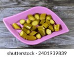 Small photo of Slices of pickled cucumber, pickle, gherkin, usually small or miniature cucumber that has been pickled in a brine, vinegar, or other solution and left to ferment, part of mixed pickles, food appetizer