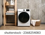 Washing machine in a gray modern laundry room