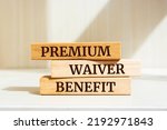 Small photo of Wooden blocks with words 'Premium Waiver Benefit'.
