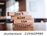 Wooden blocks with words 'Don't miss the deadline'.