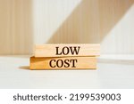 Wooden blocks with words 'low cost'. Business concept