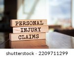 Small photo of Wooden blocks with words 'Personal injury claims'.