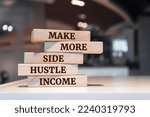 Wooden blocks with words 'Make more side hustle income'.