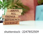 Small photo of Wooden blocks with words 'ABOVE ALL THINGS, REVERENCE YOURSELF'.
