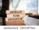 Small photo of Wooden blocks with words 'DEVELOP YOUR INTUITION'.