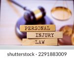 Small photo of Wooden blocks with words 'Personal Injury Law'. Legal concept