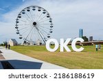 Small photo of Oklahoma City, Oklahoma USA - July 14, 2016: People enjoy a day at the Wheeler Ferris Wheel in Oklahoma City along the Oklahoma River near downtown district.