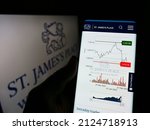 Small photo of Stuttgart, Germany - 02-06-2022: Person holding smartphone with webpage of British company St. James's Place plc on screen in front of logo. Focus on center of phone display. Unmodified photo.