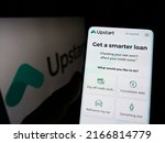 Small photo of Stuttgart, Germany - 05-15-2022: Person holding smartphone with webpage of US fintech company Upstart Network Inc. on screen in front of logo. Focus on center of phone display. Unmodified photo.