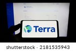 Small photo of Stuttgart, Germany - 07-15-2022: Person holding cellphone with logo of company Terraform Labs Pte. Ltd. (Terra Money) on screen in front of webpage. Focus on phone display. Unmodified photo.
