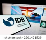 Small photo of Stuttgart, Germany - 09-07-2022: Mobile phone with logo of Inter-American Development Bank (IADB) on screen in front of business website. Focus on center of phone display. Unmodified photo.