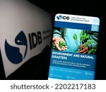 Small photo of Stuttgart, Germany - 09-07-2022: Person holding smartphone with website of Inter-American Development Bank (IADB) on screen in front of logo. Focus on center of phone display. Unmodified photo.