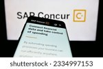 Small photo of Stuttgart, Germany - 07-11-2023: Smartphone with webpage of expense management software SAP Concur on screen in front of business logo. Focus on top-left of phone display. Unmodified photo.
