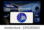 Small photo of Stuttgart, Germany - 11-12-2023: Person holding cellphone with logo of Israel Security Agency (ISA, Shin Bet) in front of webpage. Focus on phone display. Unmodified photo.
