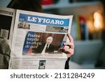 Small photo of Paris, France - Feb 23, 2022: Woman reading French newspaper Le Figaro headlines Russian president Vladimir Putin torpedoed peace efforts after signing recognition of Donbass regions