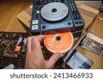 Small photo of Paris, France - Oct 24, 2023:Paris, France - Oct 24, 2023: Watch as the CD of MGMT's Oracular Spectacular is smoothly inserted into the Denon DJ mixing equipment, bringing music to life for your party