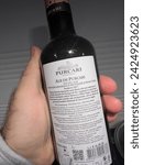 Small photo of Paris, France - Mar 8, 2022: POV male hand holding bottle with Purcari Alb de Purcari white wine - Made in Moldova