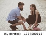 Love at first sight. Man and woman falling in love. Bearded man and cute woman met on street. Hipster helping and looking at pretty girl. Couple in love on summer day. Enjoy romantic date and dating.