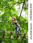 Small photo of Go Ape Adventure. Climber child on training. Child climbing on high rope park. Children fun. Cargo net climbing and hanging log. Active children. Roping park.