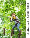 Small photo of Child boy having fun at adventure park. Go Ape Adventure. Cargo net climbing and hanging log. Early childhood development. Artworks depict games at eco resort which includes flying fox or spider net