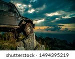 Offroad car on mountain road. Shock absorber for off road car. Car brakes with absorbers. Car tire. Tire for offroad