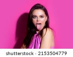 Small photo of Woman shows tongue. Model with sticking tongue out. Girl showing tongue. Emotional mouth with licking lips.