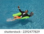 Small photo of Businessman in suit with laptop in swimming pool. Crazy business man on summer vacation. Excited businessman in wet suit in swim pool. Funny business man, crazy comic business concept. Remote working.