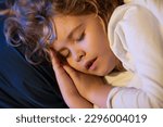 Small photo of Boy is sleeping on the bed with his mouth open, snoring. Kid sleeps face close up. Child sleep, napping. Cute kid sleeping in bed. Sleeping kid face.