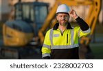 Small photo of Builder in a construction site. Builder with excavator ready to build new house. Construction builder wear building uniform on excavation truck digging, builder with buildings construction background.