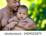 Small photo of Fathers day. Close up portrait of african american father kissing multiracial baby. Father kiss Biracial child. Closeup face of Father with baby kiss. Fathers kiss. Biracial baby on fathers hand.