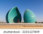 Small photo of Baghdad, Iraq - November 2022: Split turquoise domes of Al Shaheed war memorial also called as Martyr's monument at the centre of the two half-domes is the Iraqi flag