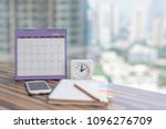 Open Notebook Calendar June 2018 with smartphone diary clock pencil blurred background modern office. Event organizer midyear half year planning, timetable, schedule. Calendar 2018 Concept.