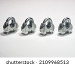Small photo of Wire rope clamps to secure wire ropes. Wire rope clips on white background. Tension cable assembly accessories