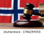 Small photo of Justice and court concept in Kingdom of Norway. Judge hammer on a flag background.